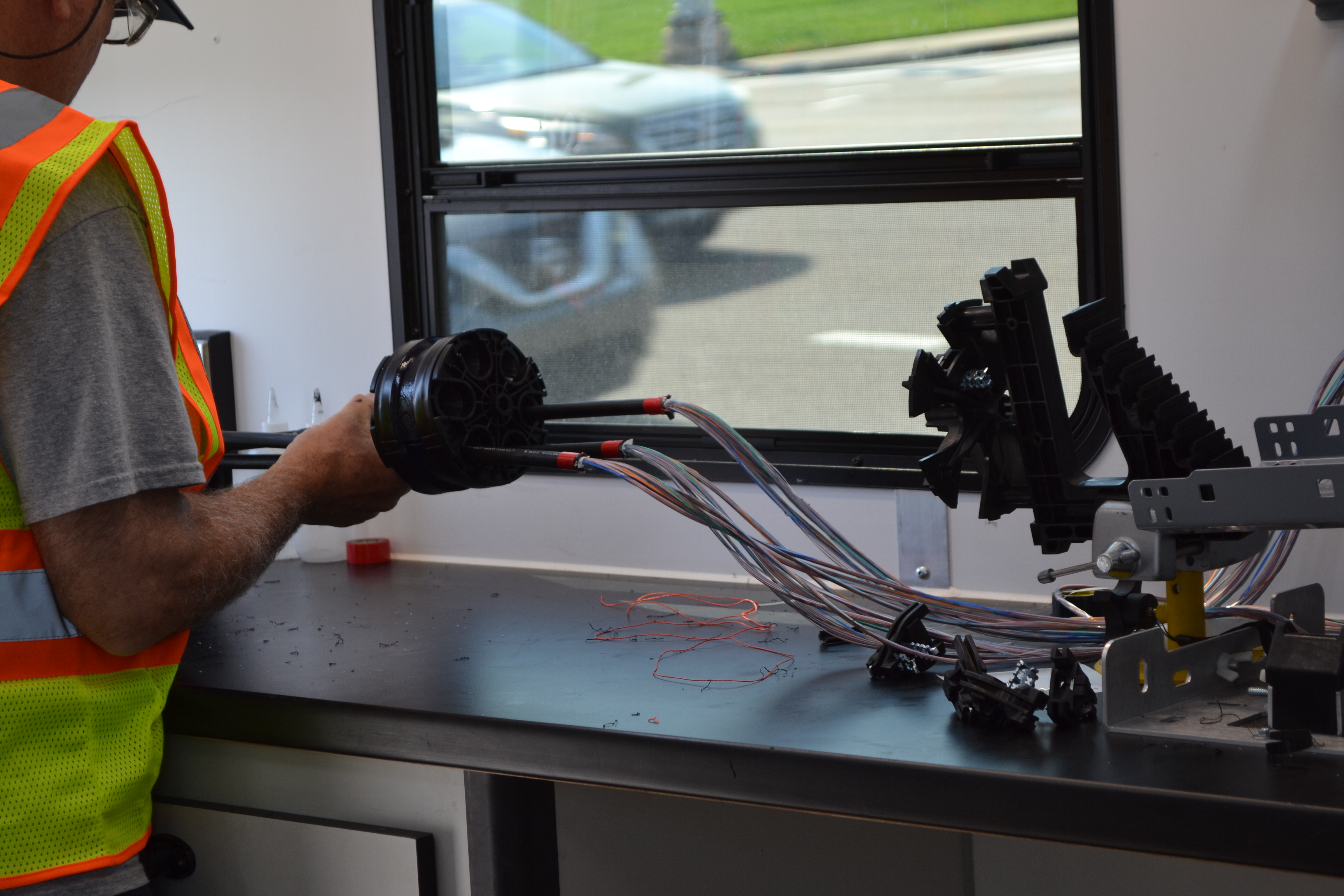 A KUB team member working on splicing fiber lines.